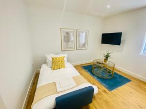 a small bedroom with a bed and a tv at Norfolk House 