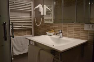 a bathroom with a white sink and a mirror at Hellorooms in Pescara