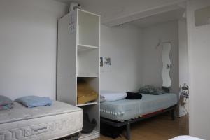 a room with a bed and a white cabinet at Appartement spacieux Lille in Lille