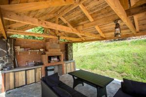 an outdoor patio with a table and a grill at Woodpecker Georgia in Batumi