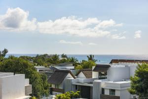 a view of buildings with the ocean in the background at One Bay Penthouse in Grand Baie