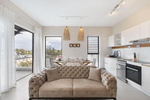 a living room with a couch in a kitchen at One Bay Penthouse in Grand Baie