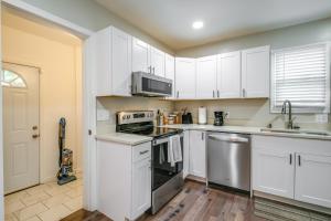 a kitchen with white cabinets and stainless steel appliances at Charming Roanoke Vacation Home - 1 Mi to Downtown! in Roanoke