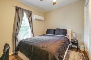 a bedroom with a bed and a large window at Charming Roanoke Vacation Home - 1 Mi to Downtown! in Roanoke