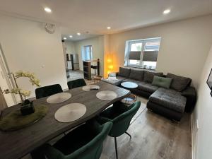 a living room with a table and a couch at HT Appartement Nr 4 in Greppin