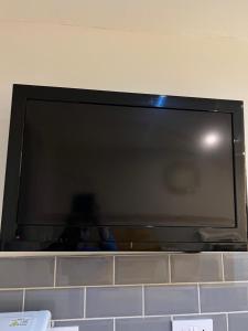 a flat screen tv sitting on top of a wall at Stonebarn Lane in Halton