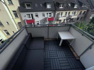 a staircase with a bench on a balcony with a building at Rü-Premium Apartments in Essen
