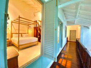 a bedroom with a bed and a staircase in a room at Ivy Lane Galle Fort in Galle
