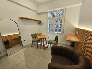 a living room with a couch and a table and a window at Studio Admirable Recoleta in Buenos Aires