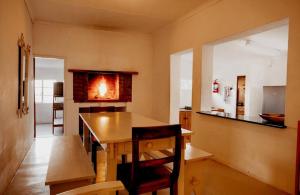 a kitchen with a wooden table in a room at Vaalwater Lodge & Bush Camp in Willowmore