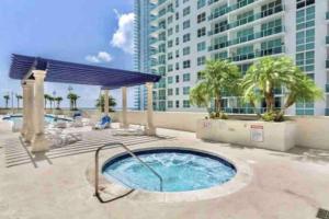 a hot tub on a patio with a building at Iconic 1BR HighRise Condo Brickell-FreeParking in Miami