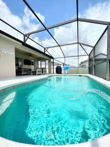 a large swimming pool in a building at Luxury Modern Pool House close to theme parks. in Kissimmee