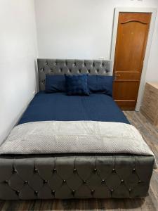 a large bed in a bedroom with a blue mattress at Stonebarn Lane One Bed in Halton