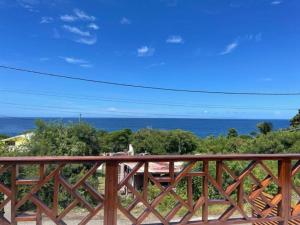 a view of the ocean from a wooden deck at Maïya in Bouillante