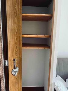 a wooden book shelf in a bedroom at Studio confortable et chaleureux, vue magnifique in Saint-Léger-les-Mélèzes