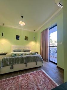 a bedroom with a bed and a large window at Hotel Florida in Durrës