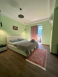 a bedroom with a bed with a rug and a window at Hotel Florida in Durrës