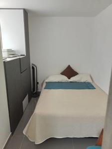 ein Schlafzimmer mit einem großen weißen Bett und einem TV in der Unterkunft El mirador paisa in Bello