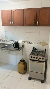 a kitchen with a stove and a camera in it at casa prive paulista in Paulista