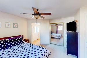 a bedroom with a bed and a ceiling fan at The Renton Rest House in Renton