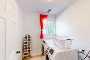 a washing machine in a laundry room with a window at The Renton Rest House in Renton +19 photos