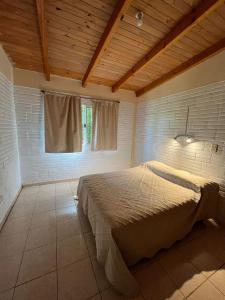 a bedroom with a large bed with a window at La Casita de Irene in Puerto Rico