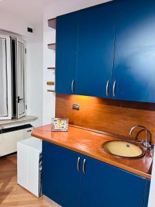 a bathroom with blue cabinets and a sink at ALLOGGIO TURISTICO IL TEMPIO in Perugia