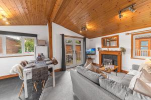 a living room with a couch and a table at Bowness 45 - 2 bedroom Lake Windermere Lodge in Windermere