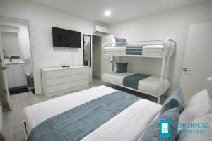a bedroom with two bunk beds and a flat screen tv at 251 Airport/Top House Apartments in Miami