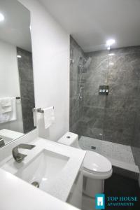 a bathroom with a sink and a toilet and a shower at 251 Airport/Top House Apartments in Miami