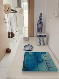 a book sitting on a counter with a vase at Famille Kominos in Katárrakhon +14 photos