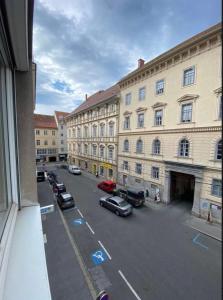 a view of a street with cars parked in front of buildings at “Opera House” Apartment Graz - Self Check-In in Graz