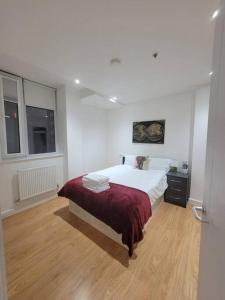 ein Schlafzimmer mit einem großen Bett und Holzboden in der Unterkunft 1 Bedroom Flat in London CB46 in Croydon
