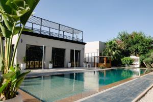 a swimming pool in the backyard of a house at Palais Jena Hotel & Spa in Marrakesh