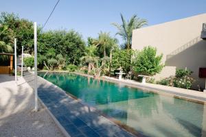 a swimming pool in front of a building at Palais Jena Hotel & Spa in Marrakesh +34 photos