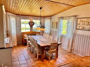 a dining room with a wooden table and chairs at Tirmo Strand in Porvoo