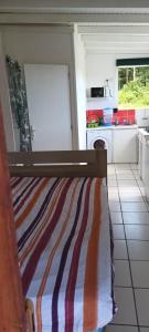 a small kitchen with a bed in a room at Weston in Deshaies