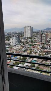 a view of a city from a balcony at Edificio Núcleo espectacular departamento in Santiago
