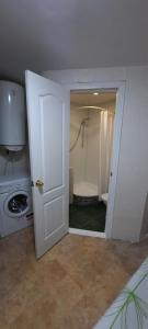 a bathroom with a shower and a toilet and a door at Гостевой дом in Odesa