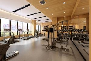 a gym with a lot of treadmills and machines at Fairfield by Marriott Harbin Downtown in Harbin