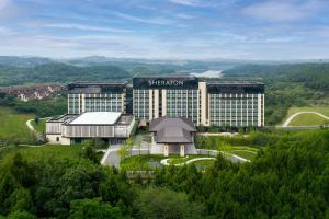 a large building with a sign on top of it at Sheraton Mianyang in Mianyang