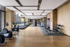 a gym with rows of exercise bikes and treadmills at Sheraton Mianyang in Mianyang