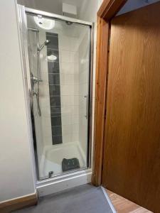 a bathroom with a shower and a tub with a glass door at Apt 1 prime central Location close cathedral in Norwich