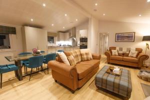 a living room with a couch and a dining room at Drumcarrow Luxury Lodges in St. Andrews