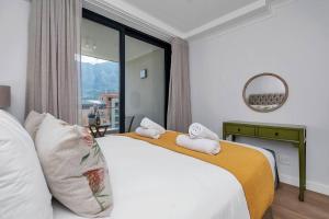 sypialnia z łóżkiem i dużym oknem w obiekcie Rooftop with breathtaking views of Table Mountain. w Kapsztadzie