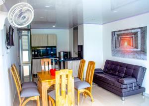 a living room with a table and a couch at Plaza Real Edificio Turístico in Melgar