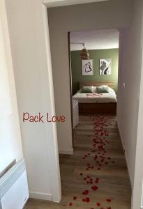 a hallway with red rose petals on the floor at Romantique Room in Muret