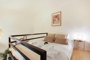 a bedroom with a bed with white sheets and pillows at Beautiful apartment 2P - Rue de l'Université Near Invalides in Paris