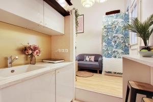 a kitchen with a sink and a living room at Beautiful apartment 2P - Rue de l'Université Near Invalides in Paris