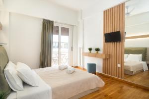 a hotel room with two beds and a television at KUKAKI ESTATE 2 in Athens
